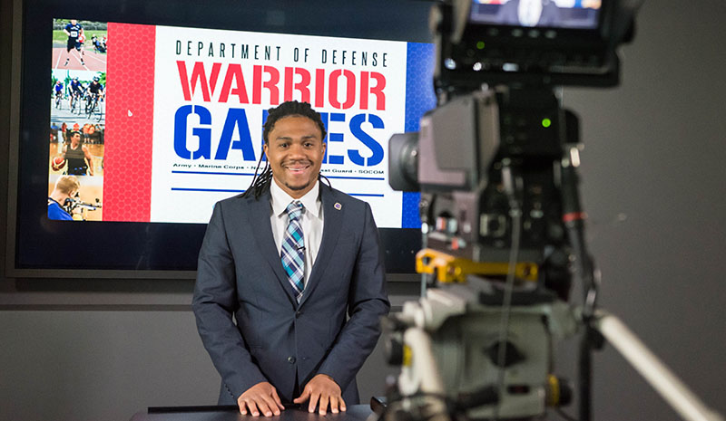 A camera filming a student at the Warrior Games.